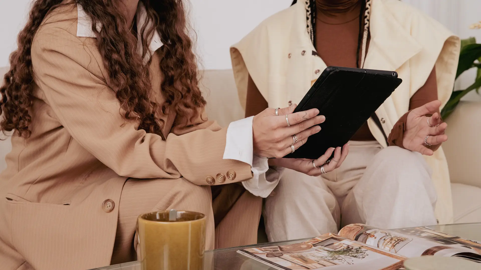 two people looking at a tablet talking about marketing